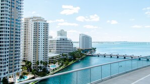 A high-rise hotel with multiple floors, a swimming pool, and a waterfront view. - W Miami (Miami)