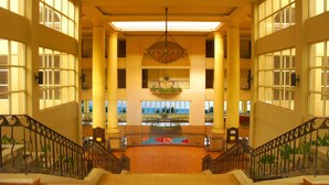 A grand lobby with a central fountain, large windows, and a symmetrical staircase design. - Corus Paradise Resort Port Dickson (Port Dickson)