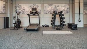 A gym with a treadmill, exercise bike, dumbbells, and a punching bag. - Novotel Singapore Robertson Quay (Singapore)