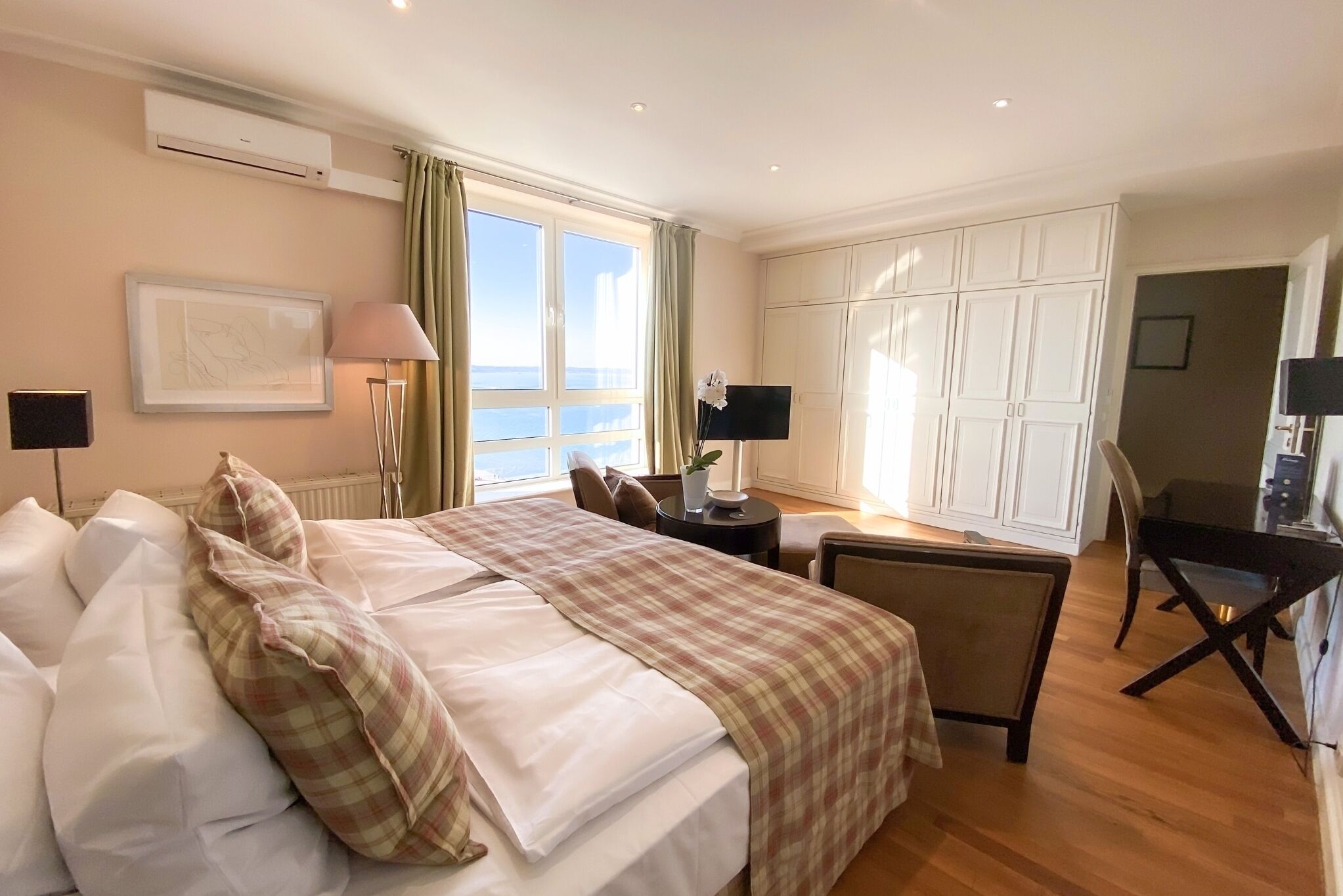 Ein Hotelzimmer mit Bett, Schreibtisch und Kleiderschrank.