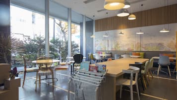 Enjoy a meal with a view at this restaurant, featuring large windows, a central island, and a variety of seating options.