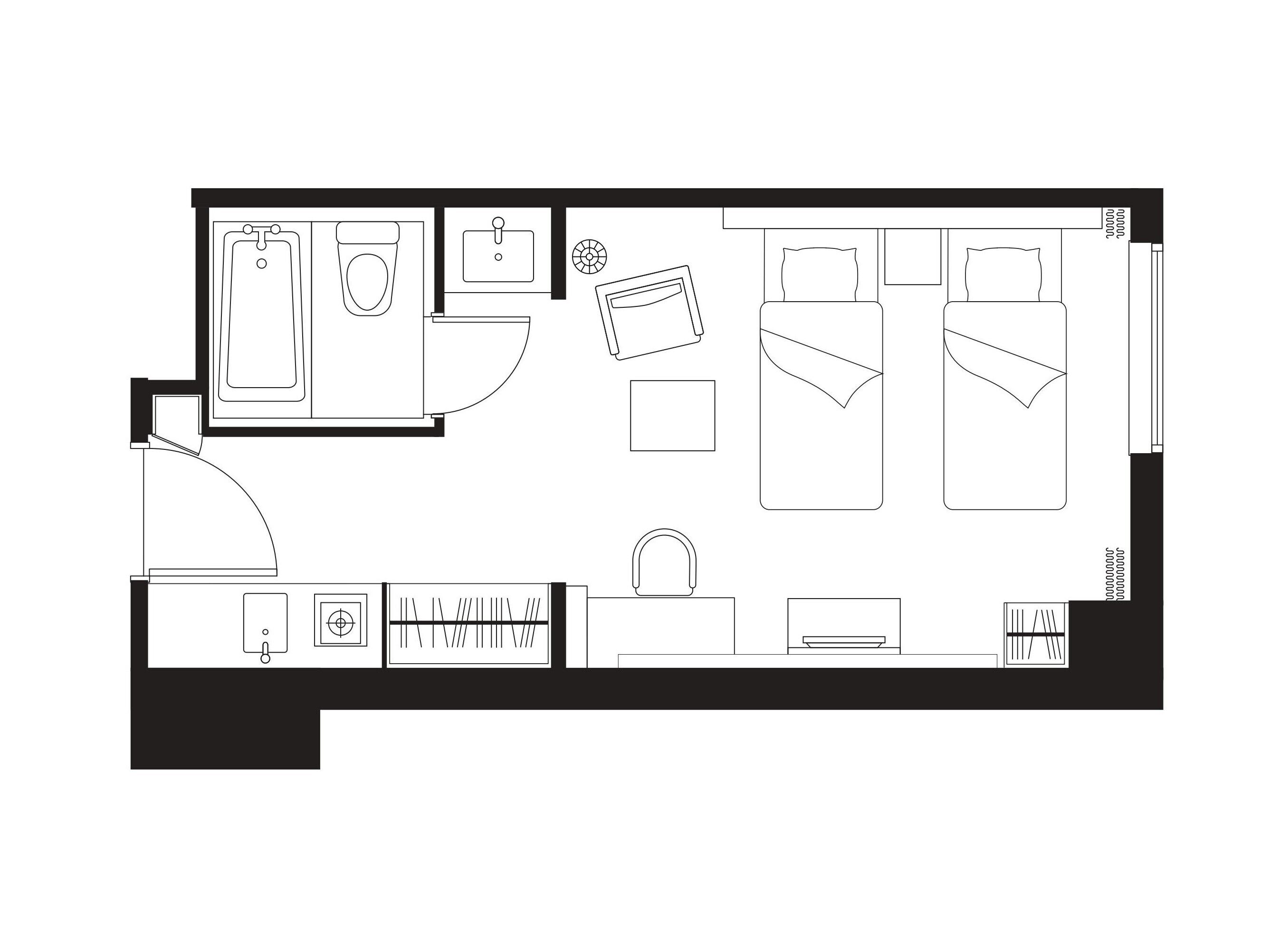 A floor plan of a hotel room with a bathroom, a kitchenette, a bed, and a seating area.