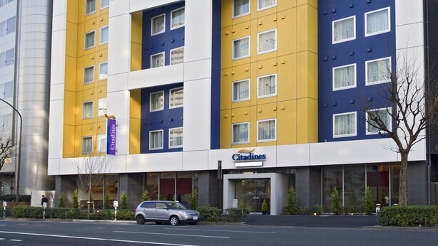A multi-story hotel with a modern facade, featuring a mix of yellow and blue panels, and a prominent 'Citadines' sign. - Citadines Shinjuku Tokyo (Tokyo)
