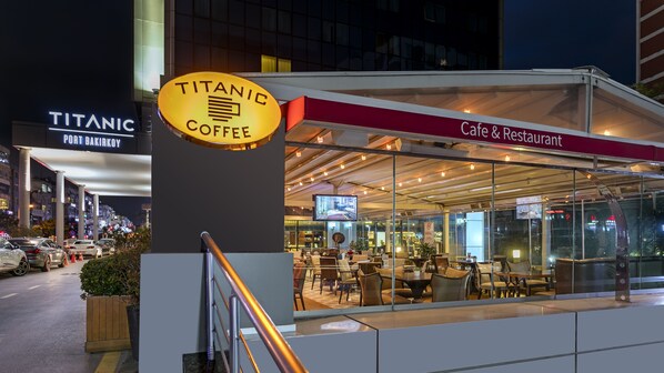 A cafe with a sign reading "Titanic Coffee" and "Cafe & Restaurant" on the exterior.