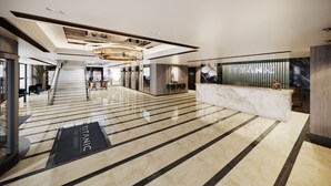 A spacious lobby with a marble floor, a reception desk, and a staircase leading to upper floors. - Titanic Port Bakirkoy (Istanbul)