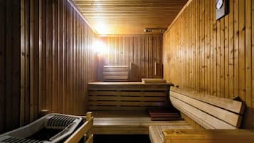 A sauna with wooden benches and a bench seat, a bench with a towel, and a bench with a towel.