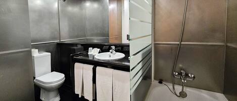 A modern bathroom with a toilet, sink, and bathtub.