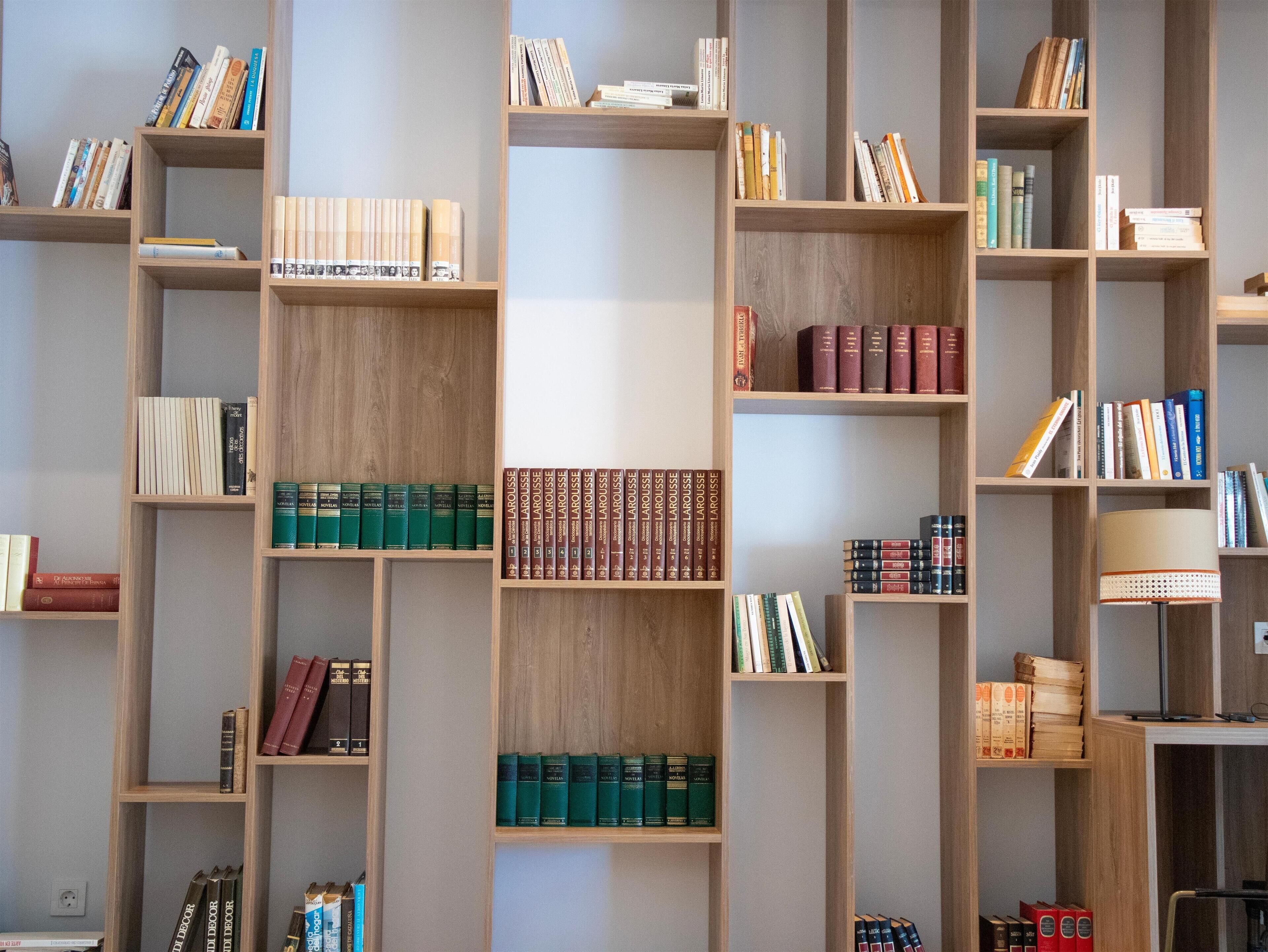 A bookshelf with multiple shelves filled with books.