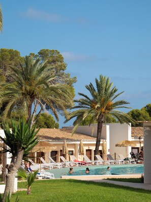 Outdoor pool, open 11:00 AM to 7:00 PM, pool umbrellas, pool loungers