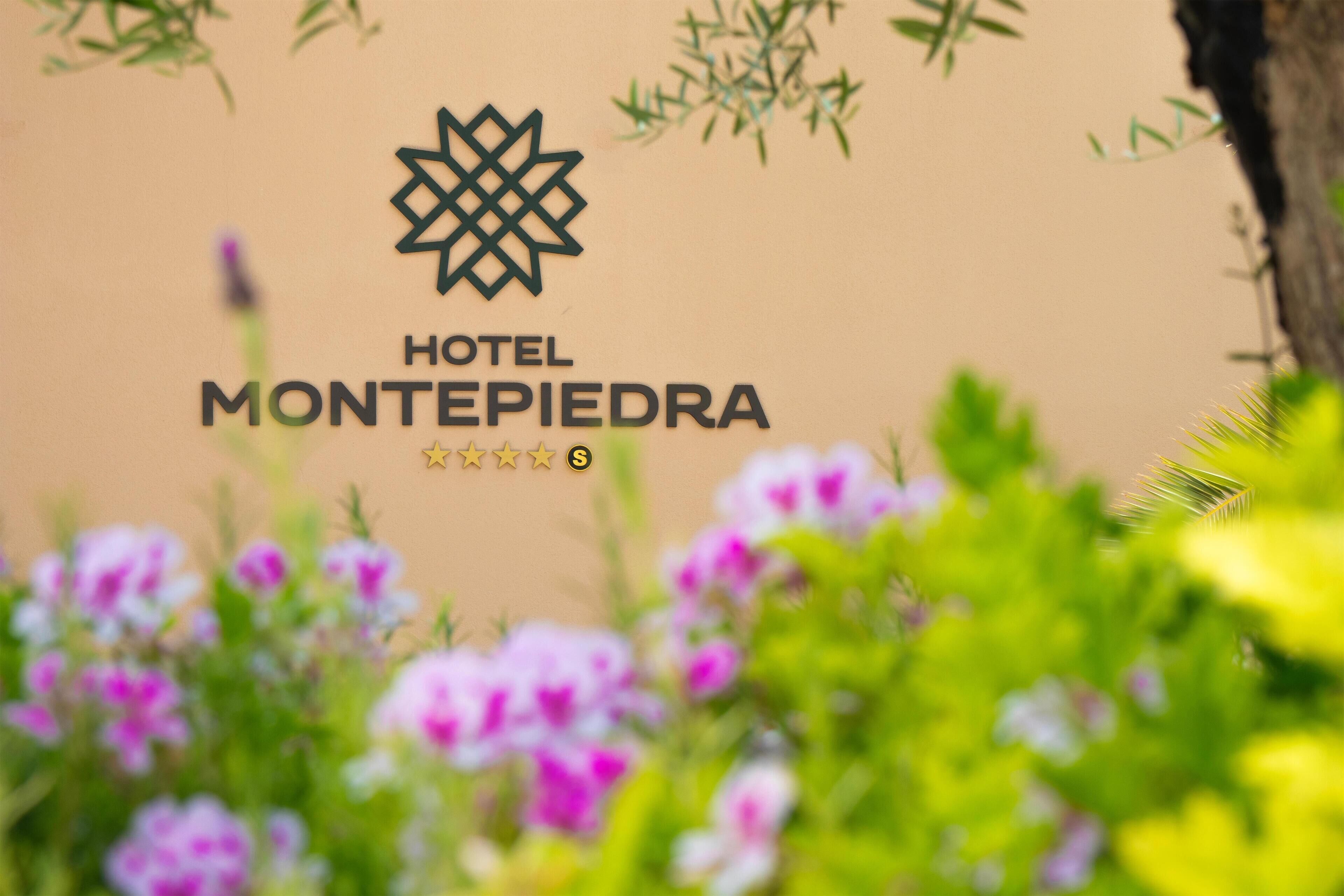 A logo with the text "HOTEL MONTEPIEDRA" and a star rating of four and a half stars.