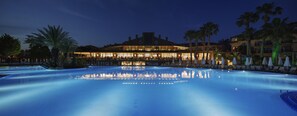 Una gran piscina al aire libre con un edificio al fondo.