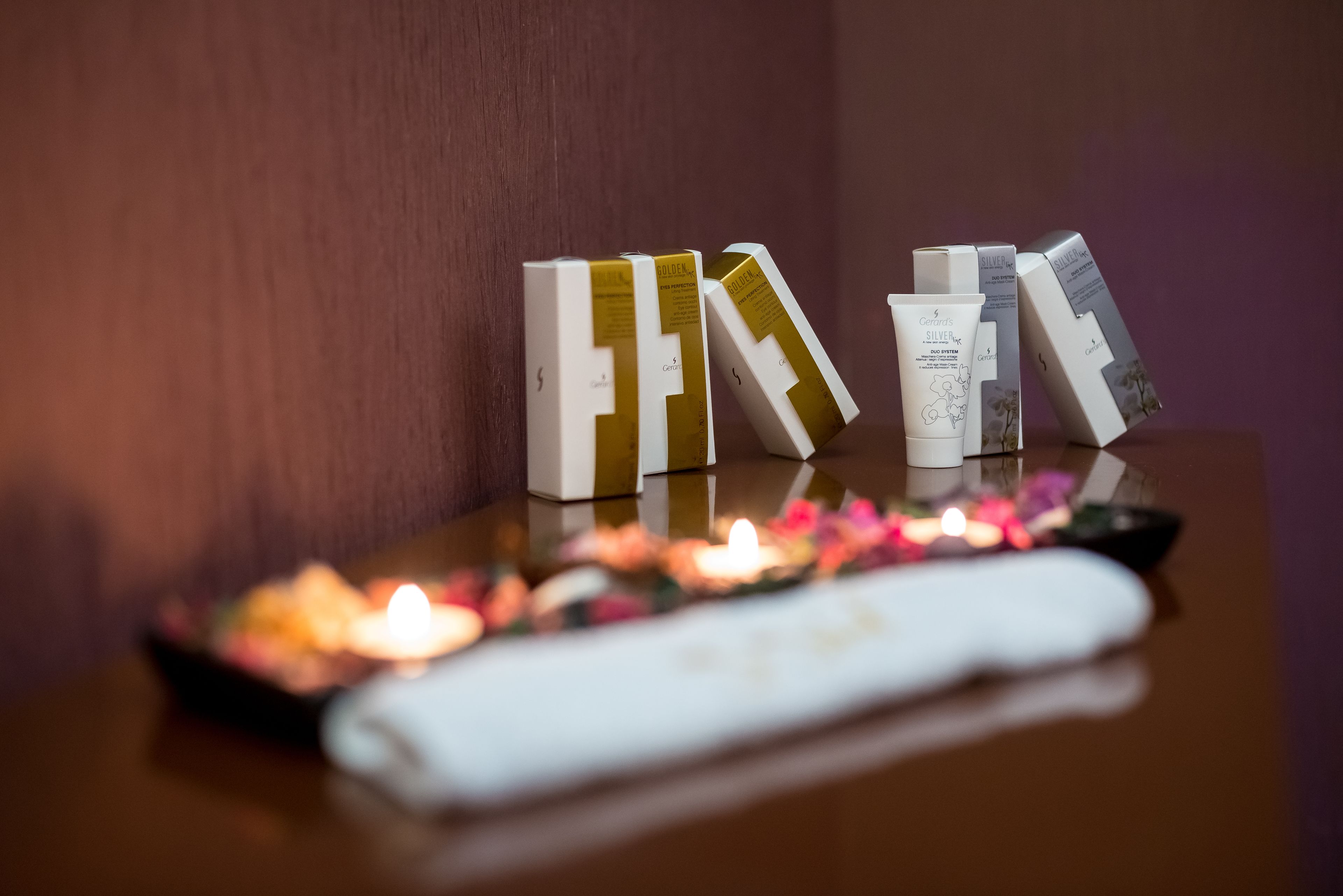 A table with toiletries and a candle.