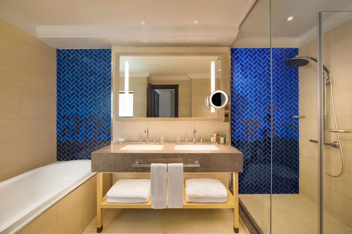 separate bathtub and shower, designer toiletries, hair dryer, bathrobes