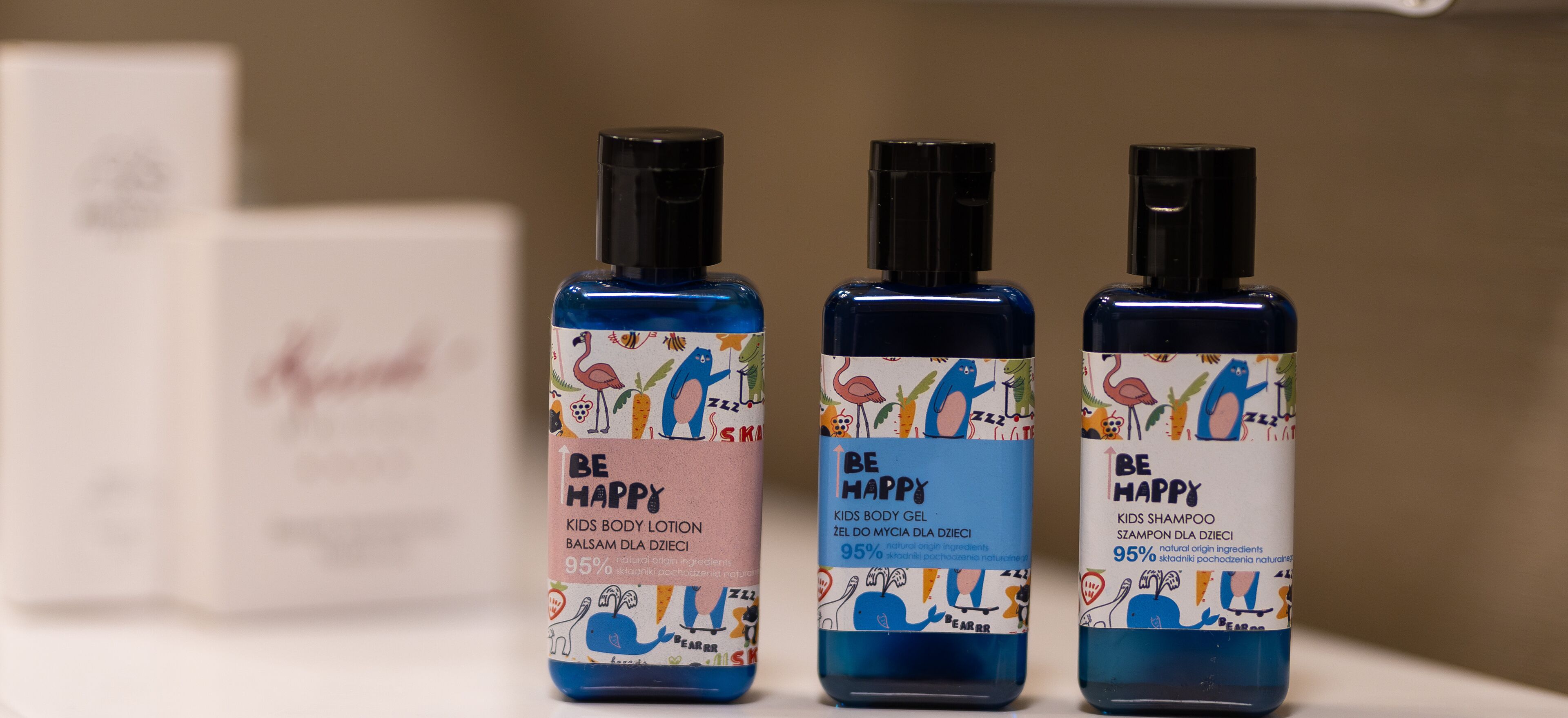 Three bottles of kids' body gel and shampoo with colorful labels.