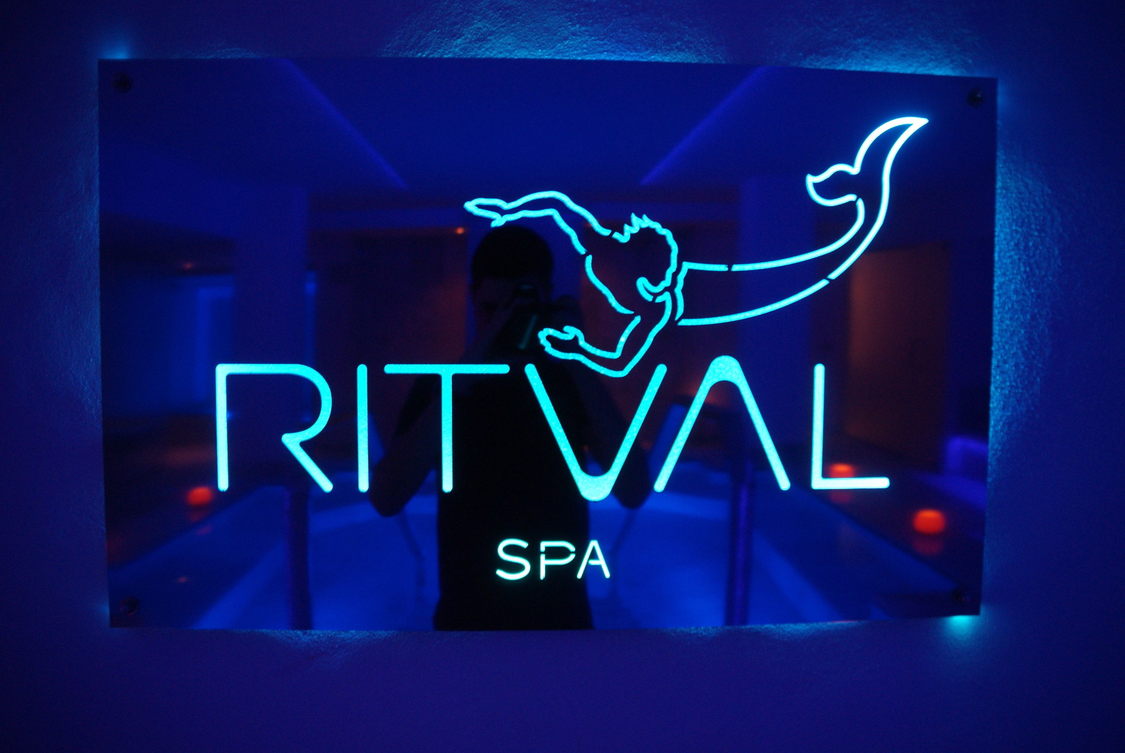 A neon sign with the word "RITVAL" and "SPA" indicating a spa service.