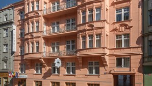 A pink building with multiple balconies and a sign reading "Hotel Taurus." - Hotel Taurus (Prague)