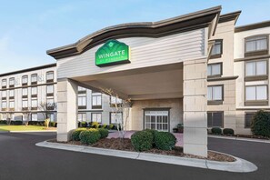 A hotel entrance with a sign reading "Wingate by Wyndham." - Wingate By Wyndham Southport (Southport)