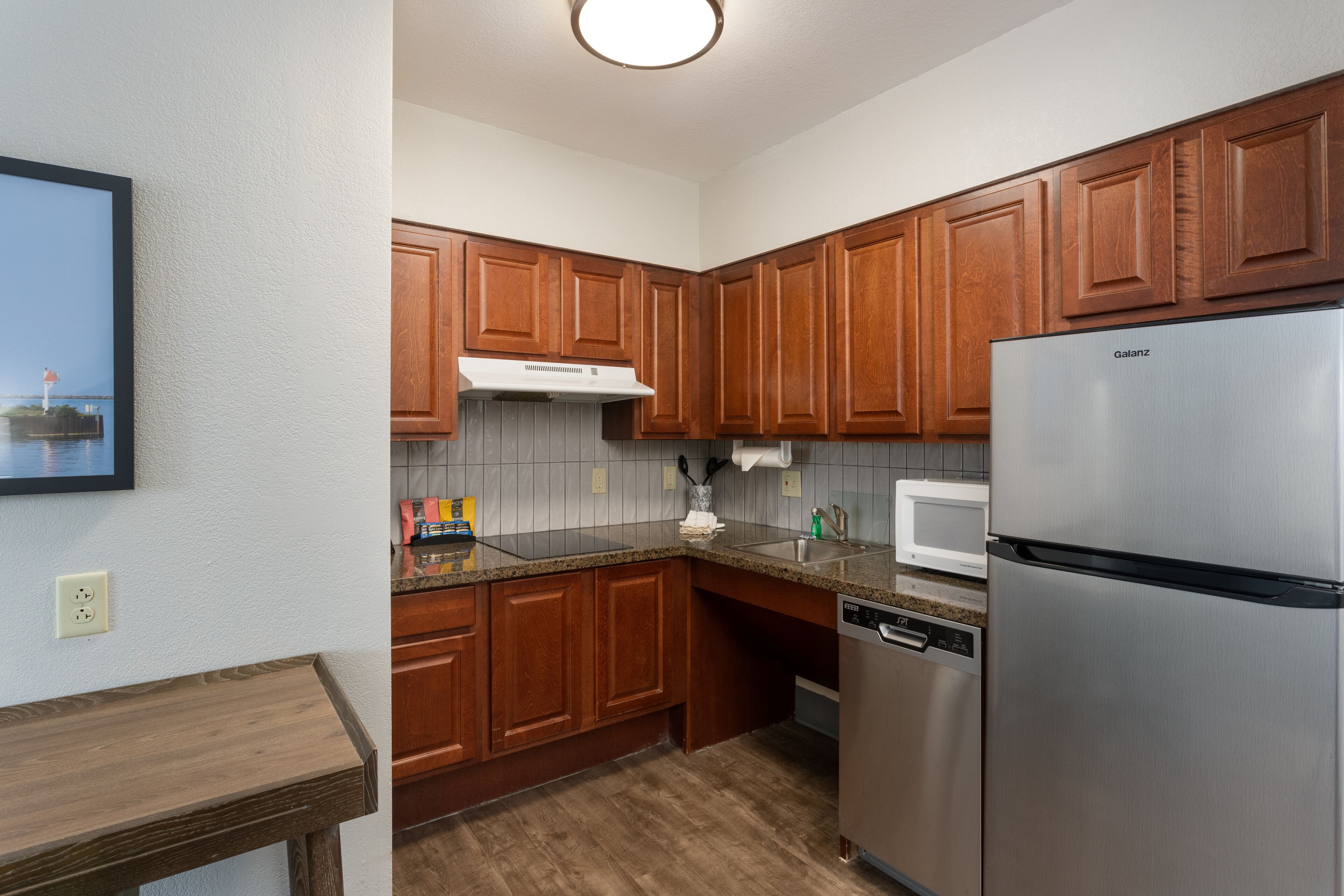 full-sized fridge, microwave, stovetop, dishwasher