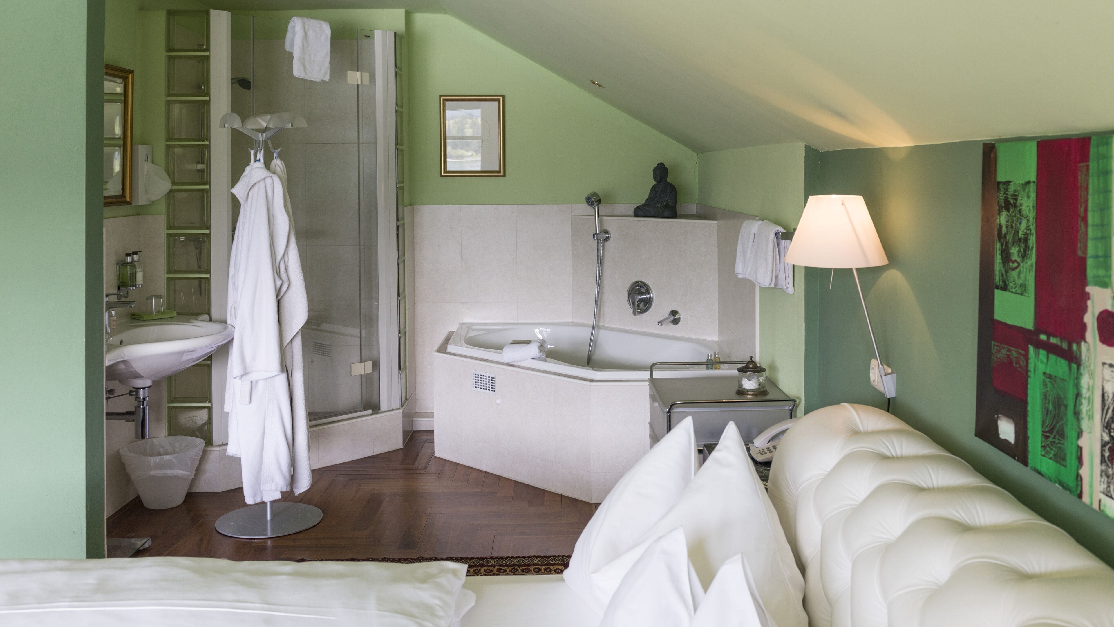 A hotel bathroom with a bathtub, shower, and sink.