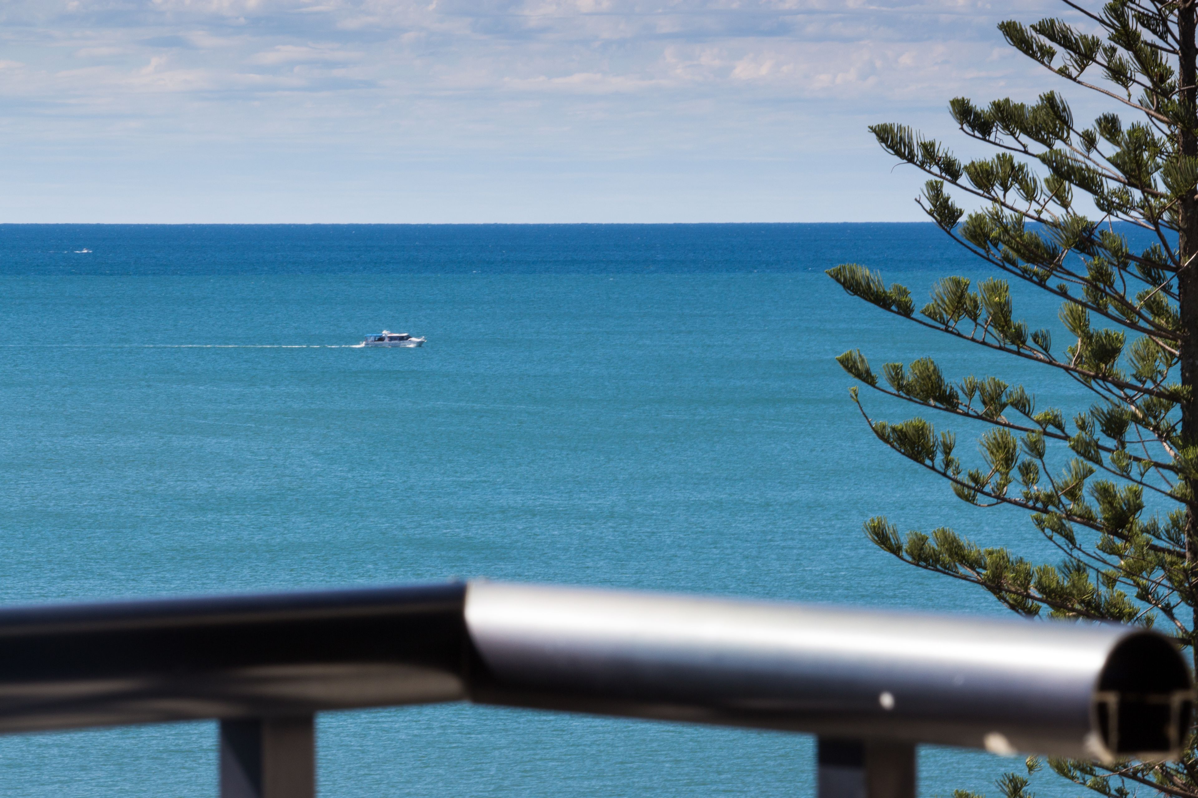 A view of the ocean with a boat in the distance.