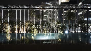 Outdoor pool, a rooftop pool, pool umbrellas, pool loungers