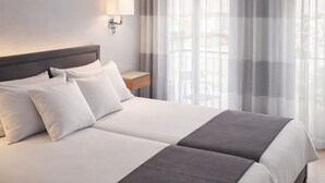 A double bed with a headboard, two bedside tables, a lamp, and sheer curtains. - Abril Nerja (Nerja)
