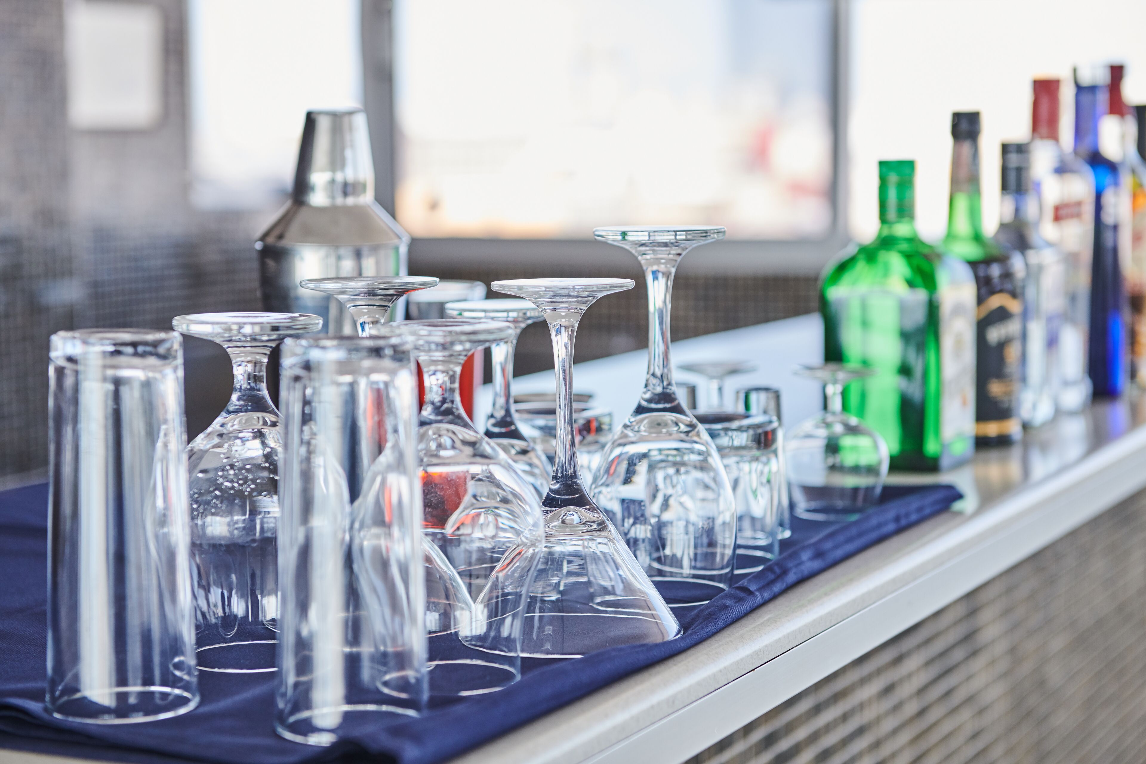 A bar area with various glassware and bottles.
