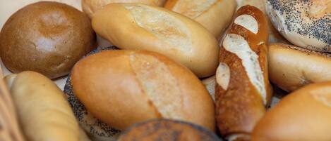 A variety of bread rolls in a basket.