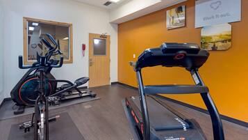 A gym with treadmills, stationary bikes, and ellipticals.