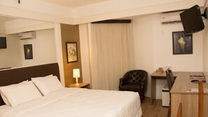 A hotel room with a large bed, a desk, a chair, a television, and a picture on the wall. - Continental Porto Alegre (Porto Alegre)