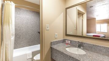 A bathroom with a bathtub, toilet, and sink.