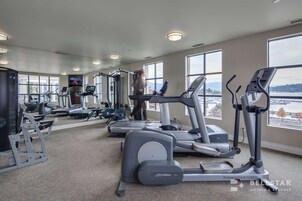 A gym with treadmills, elliptical machines, and weight machines.