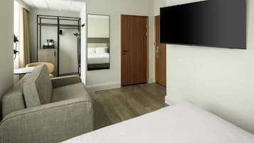 Una habitación de hotel con cama, sofá, televisión, puerta de madera y espejo.