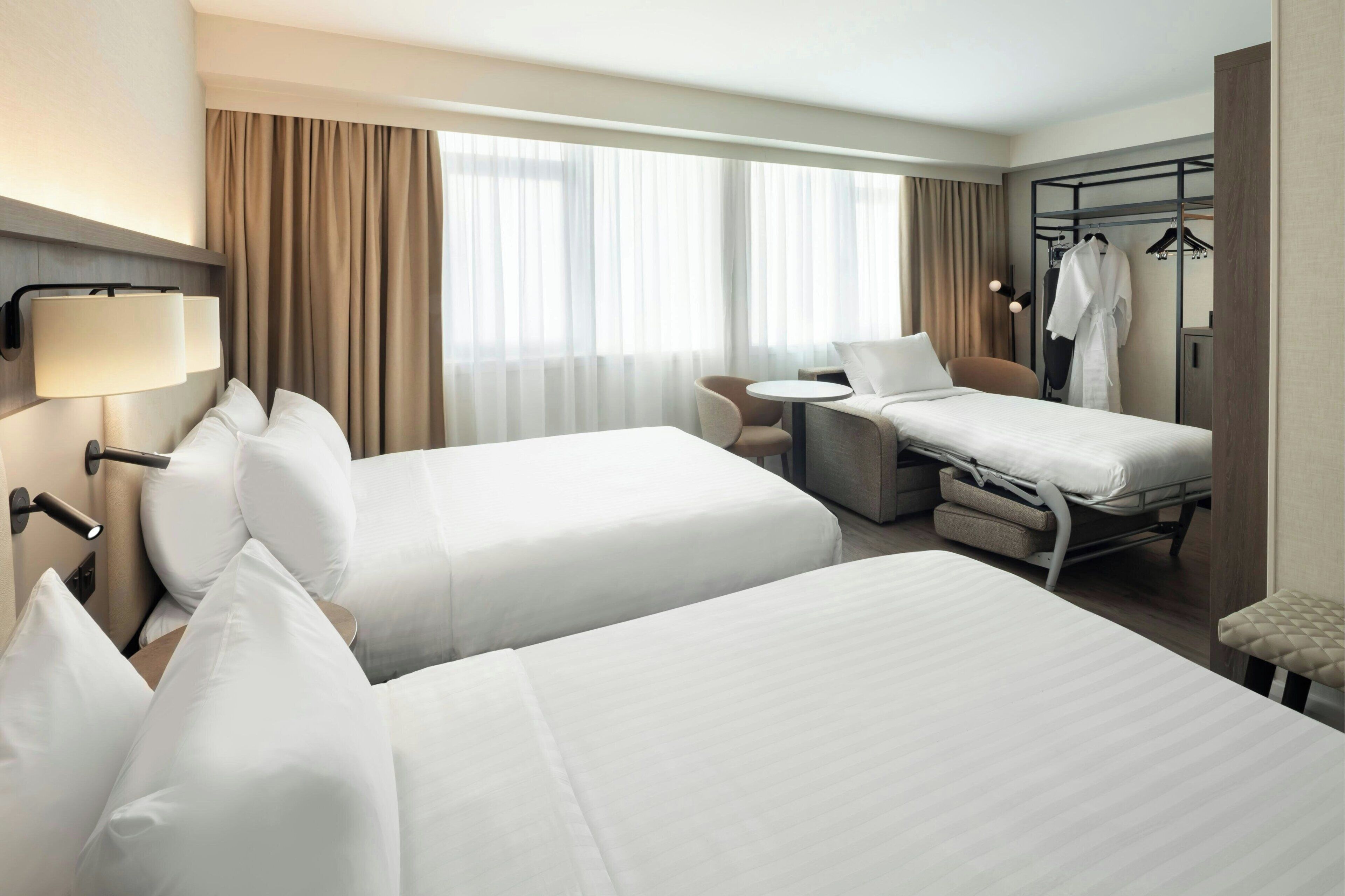 Room, 2 Double Beds | In-room safe, desk, iron/ironing board, free cots/infant beds