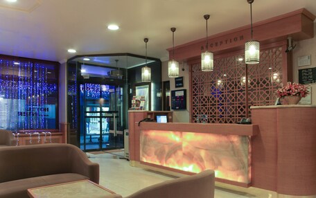 A reception area with a modern design, including a reception desk, seating area, and decorative elements.