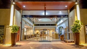 A hotel entrance with a glass facade, a central archway, and a ramp leading inside. - Club Wyndham Dunsborough, Trademark Collection by Wyndham (Marybrook)
