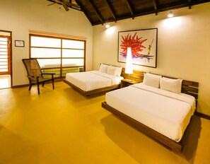 A hotel room with two beds, a chair, a large window, and a painting on the wall. - Decameron Decalodge Ticuna (Leticia)