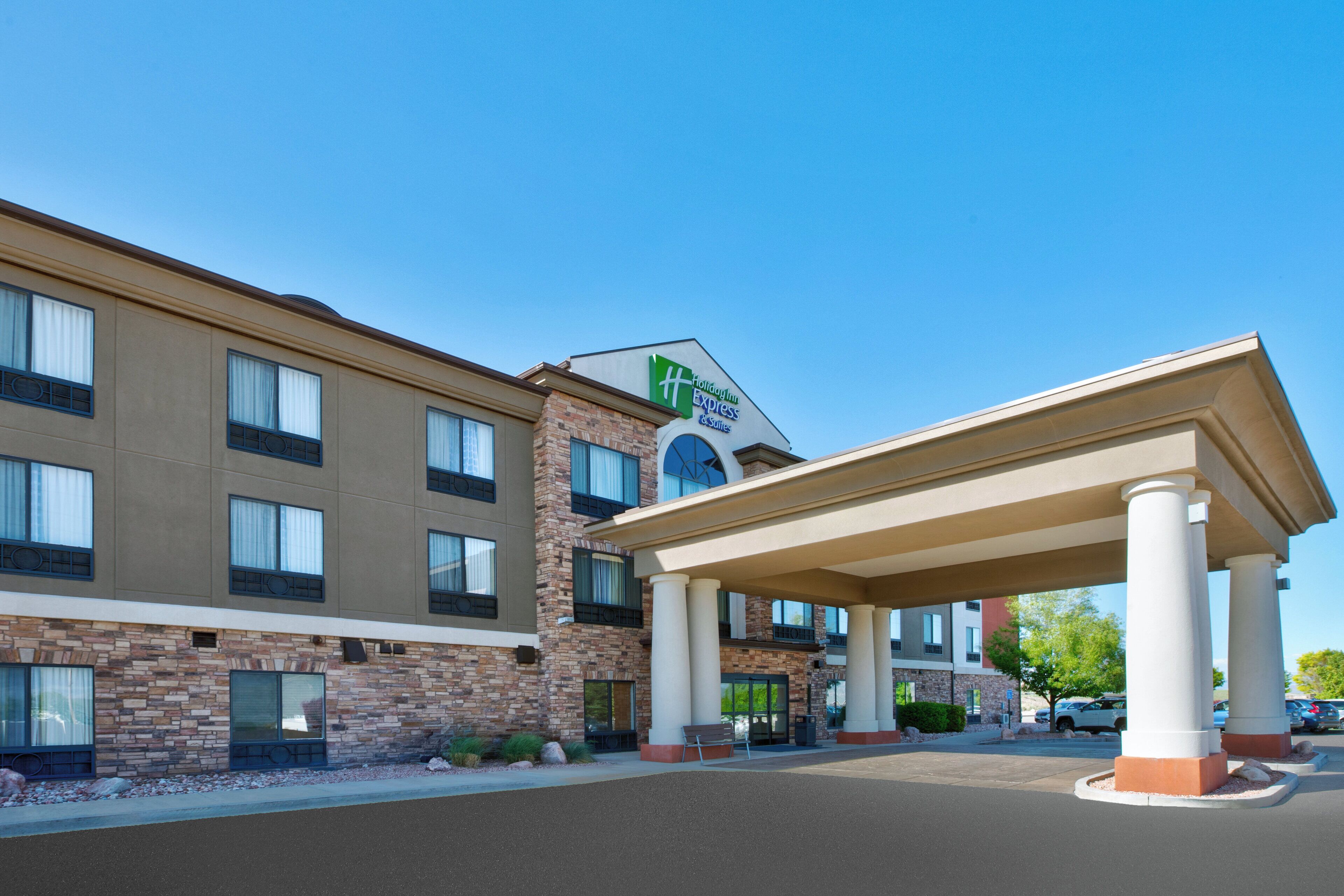 A hotel with a brick facade, a covered entrance, and a sign indicating it is a Holiday Inn Express.