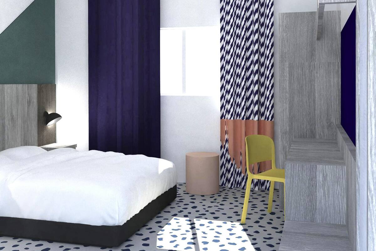 A modern bedroom with a bed, a desk, and a chair.