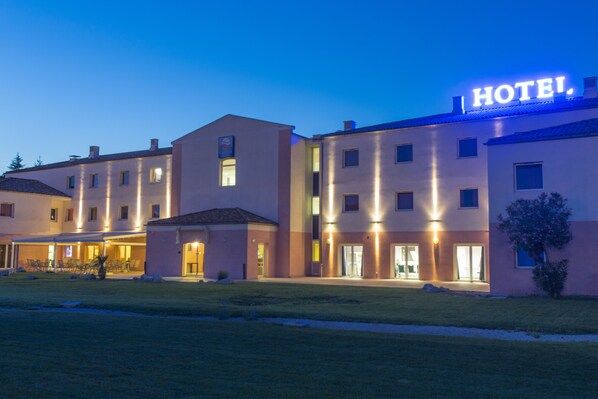 A hotel with a prominent 'HOTEL' sign, multiple entry points, and a well-lit exterior. - ibis Styles Marseille Plan de Campagne (Les Pennes-Mirabeau)