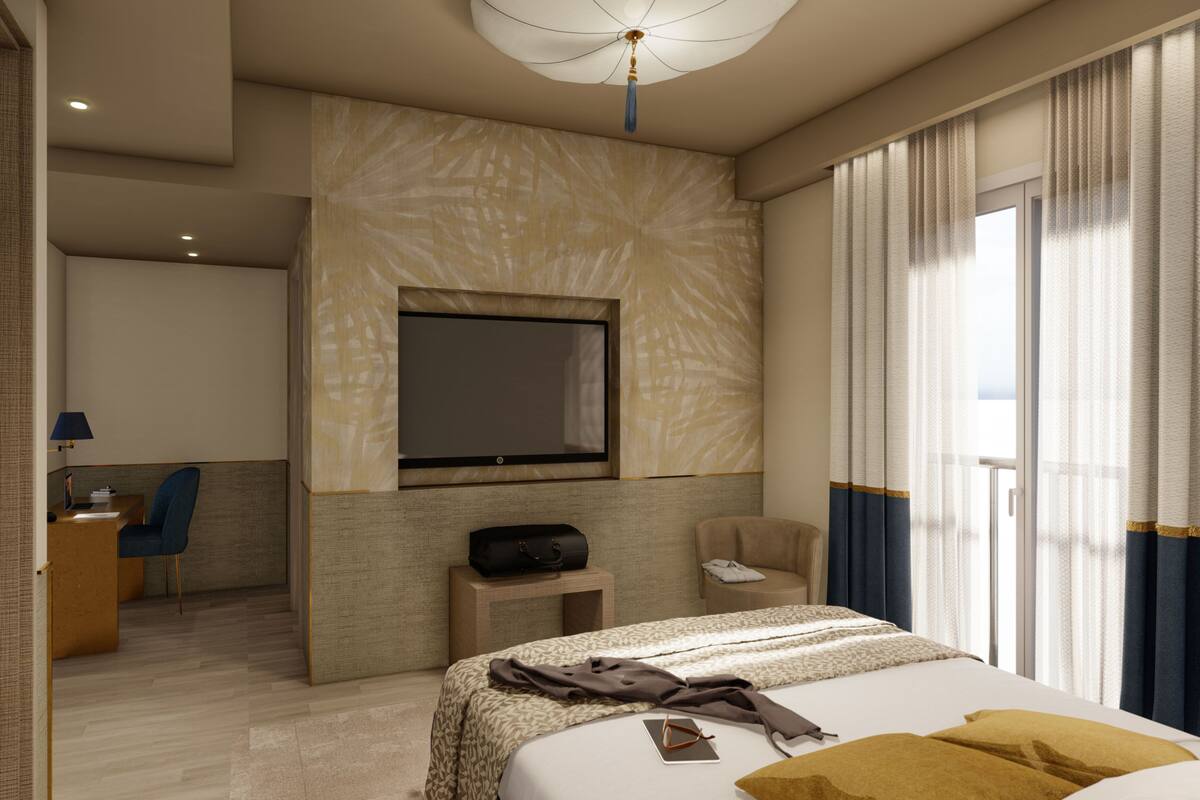 A modern hotel room with a large bed, a TV mounted on the wall, a desk with a chair, and a view of the outdoors through the window.