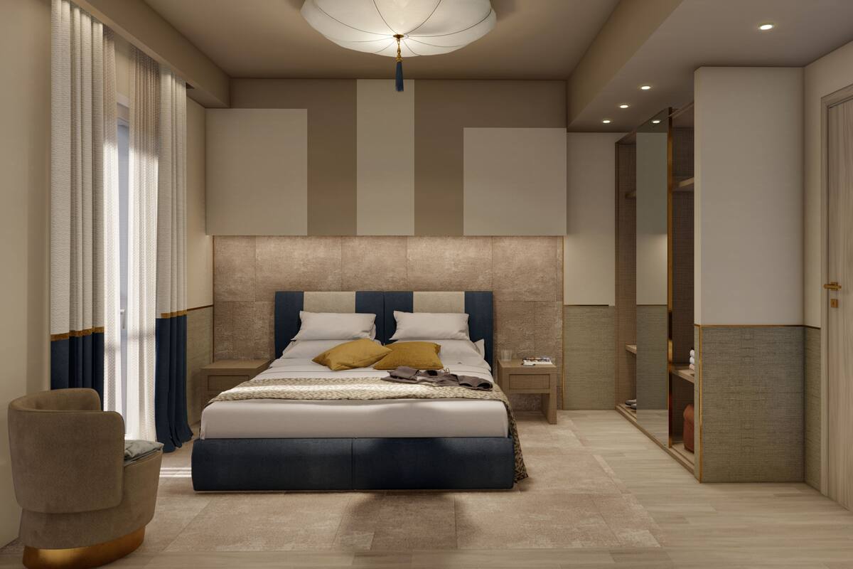 A modern bedroom with a large bed, bedside tables, a chair, and a wardrobe.