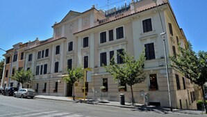 A multi-story hotel with a classic architectural style, featuring a central entrance and symmetrical windows. - Tmark Hotel Vaticano (Rome)