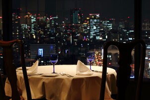 A table set for two with a cityscape view in the background.