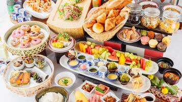 A variety of food items including pastries, fruits, and condiments arranged on a table.