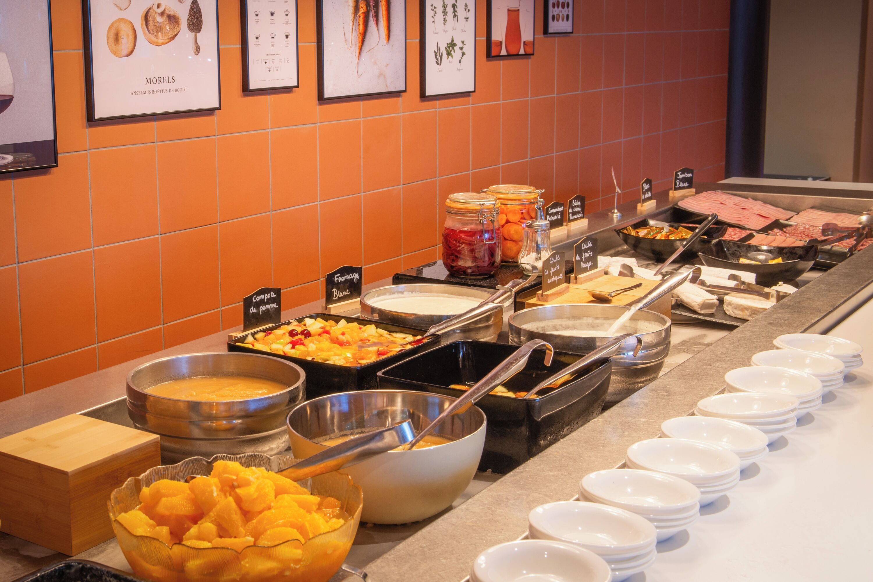A buffet with various food options and serving utensils.