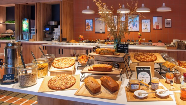 A buffet with various food items and a coffee station.