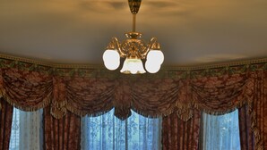 A room with a sofa, a table with a vase, and a lamp. - The Inn & Spa at Intercourse Village (Gordonville)