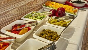 A buffet with various food items and a sign that reads "GHERITA".