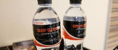 Two bottles of Sleep Within drinking water with a black cap and a label that includes the text "DRINKING WATER" and "Reverse Osmosis System."